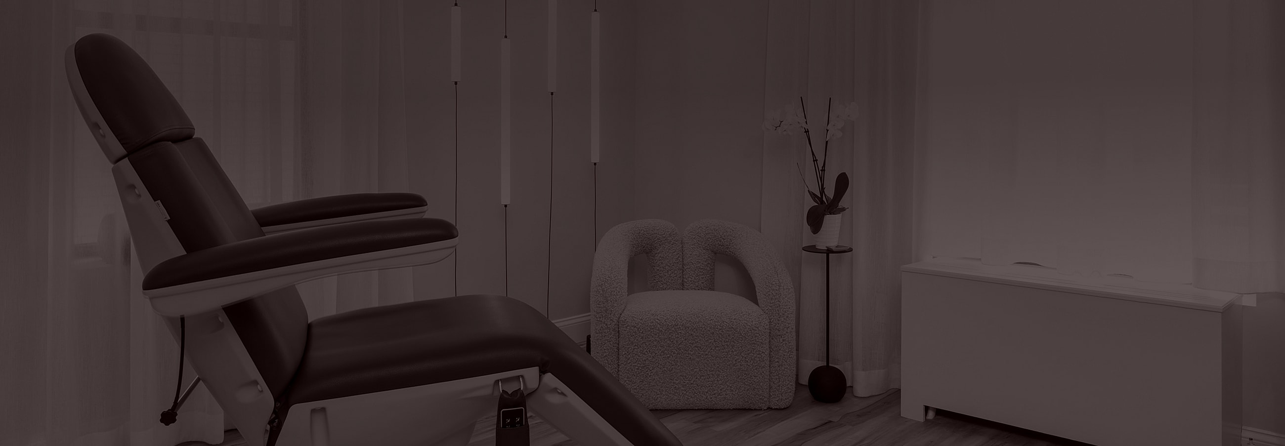 Spa treatment room with relaxing chairs and decor.