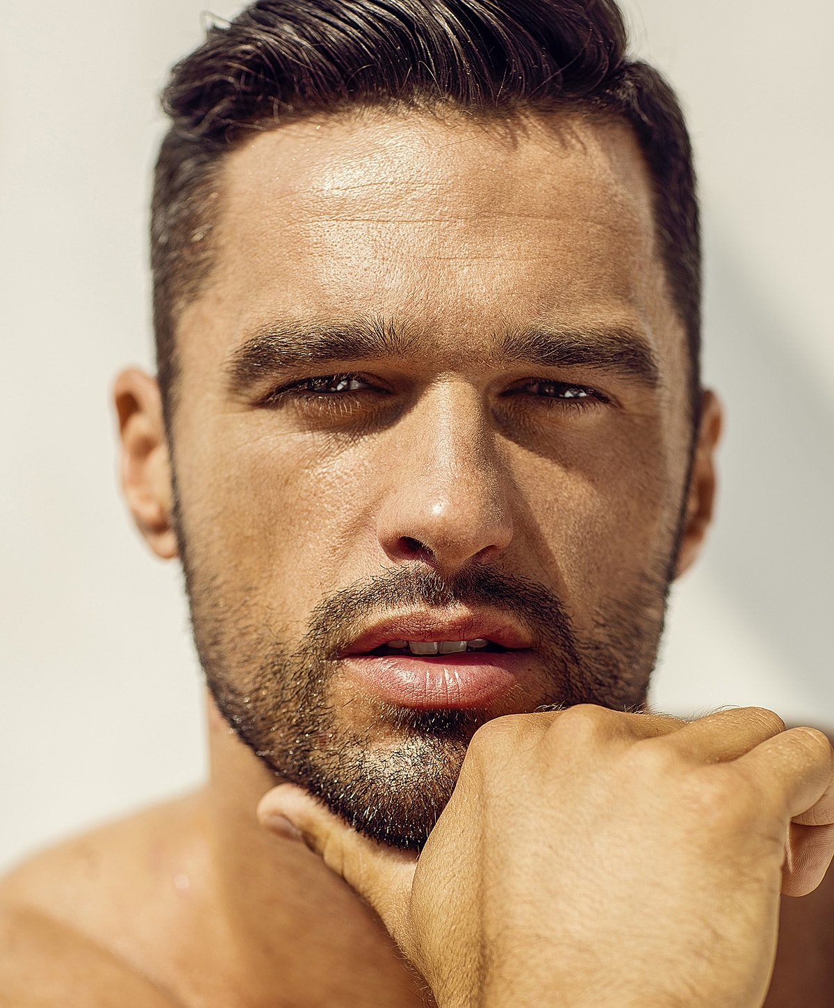 Close-up of a man with beard and thoughtful expression.