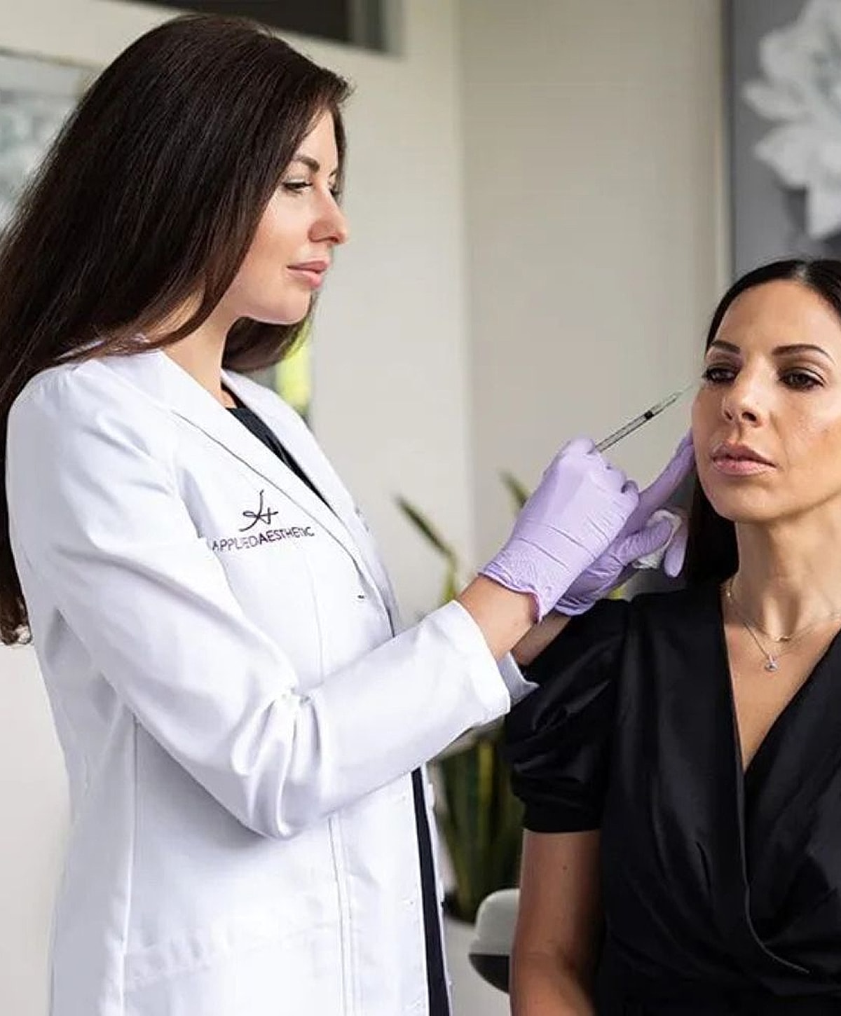 Cosmetic treatment consultation in a professional setting.