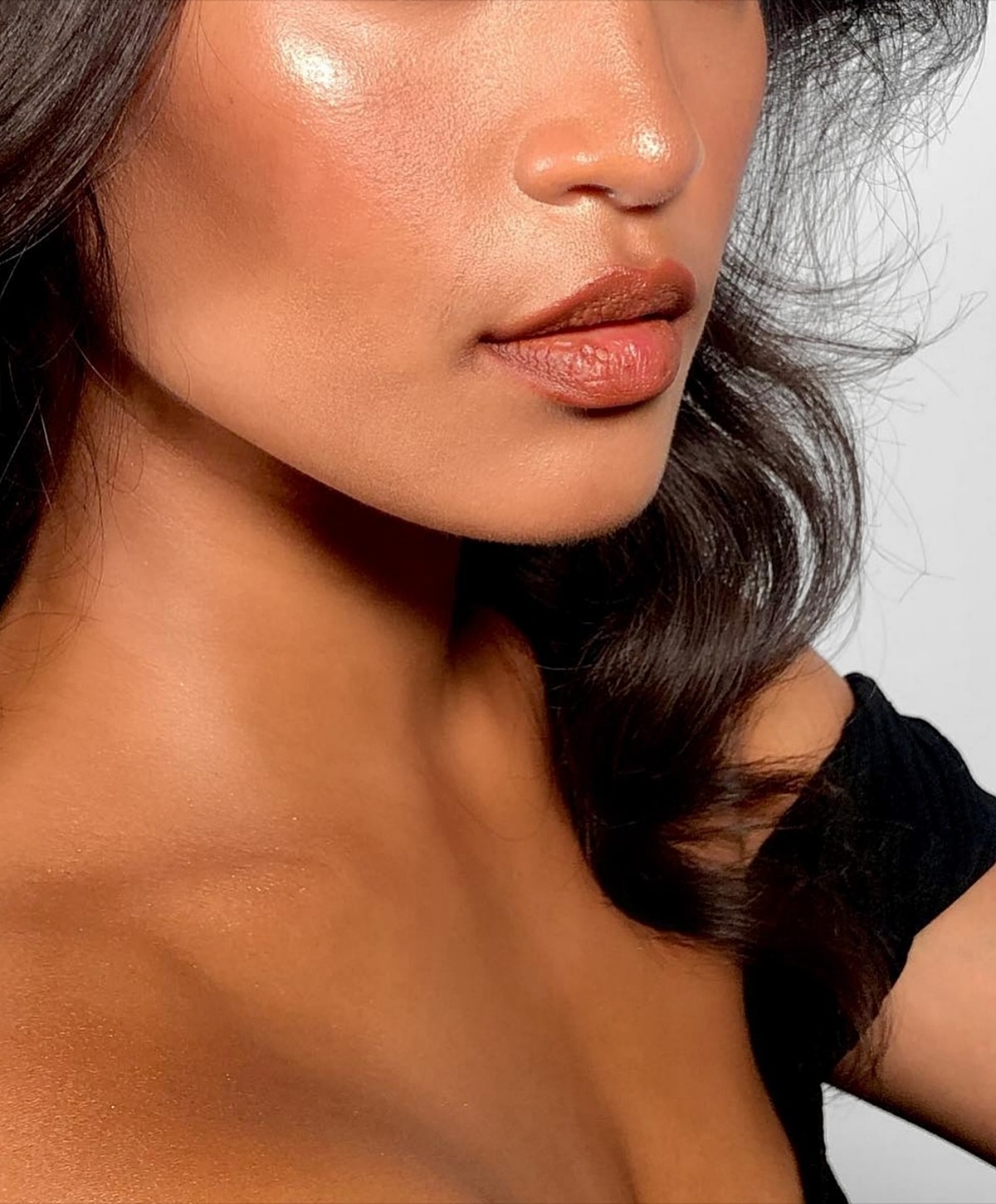 Close-up of woman's face and shoulder.