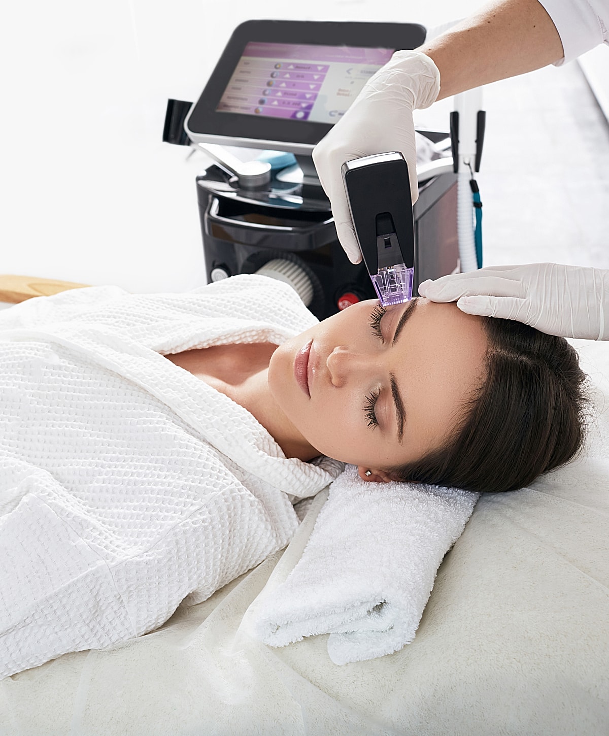 Woman receiving facial treatment in spa setting.