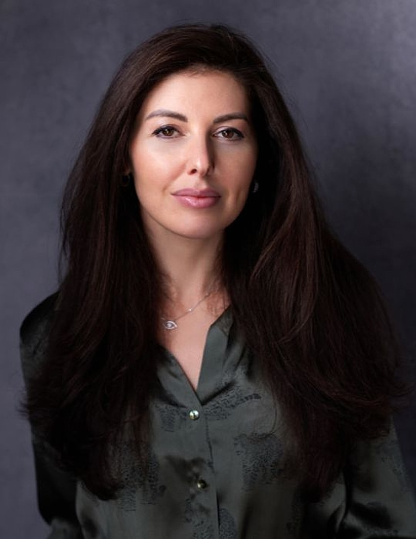 Woman with long hair in green blouse.