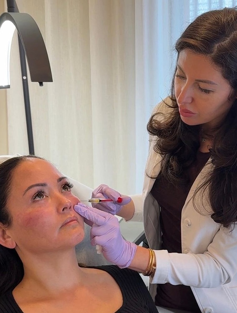 Client receiving facial treatment in clinic setting.