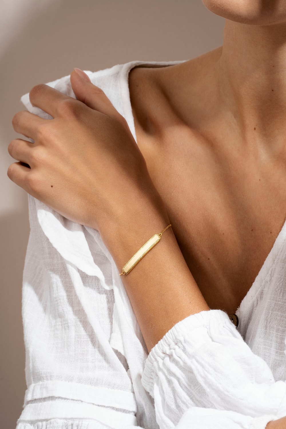 Gold bracelet on a woman's wrist.