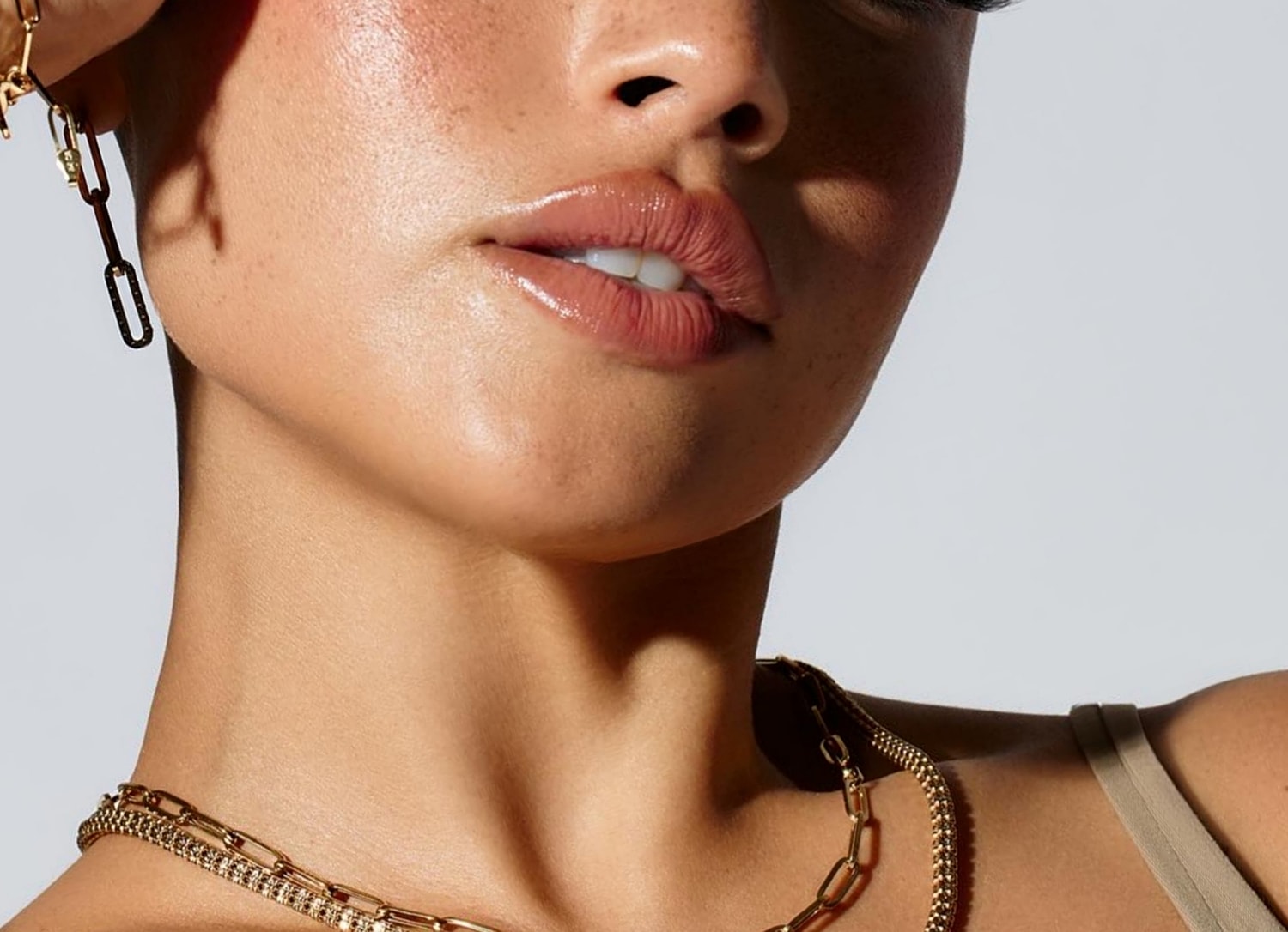 Close-up of model's face with jewelry.