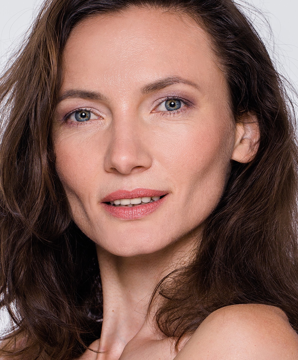 Portrait of a woman with long, wavy hair.