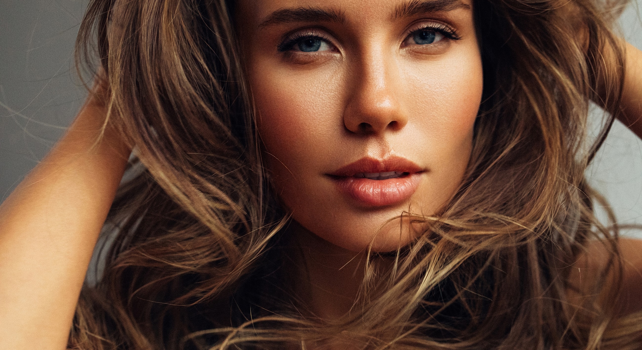 Close-up of a woman with flowing hair.