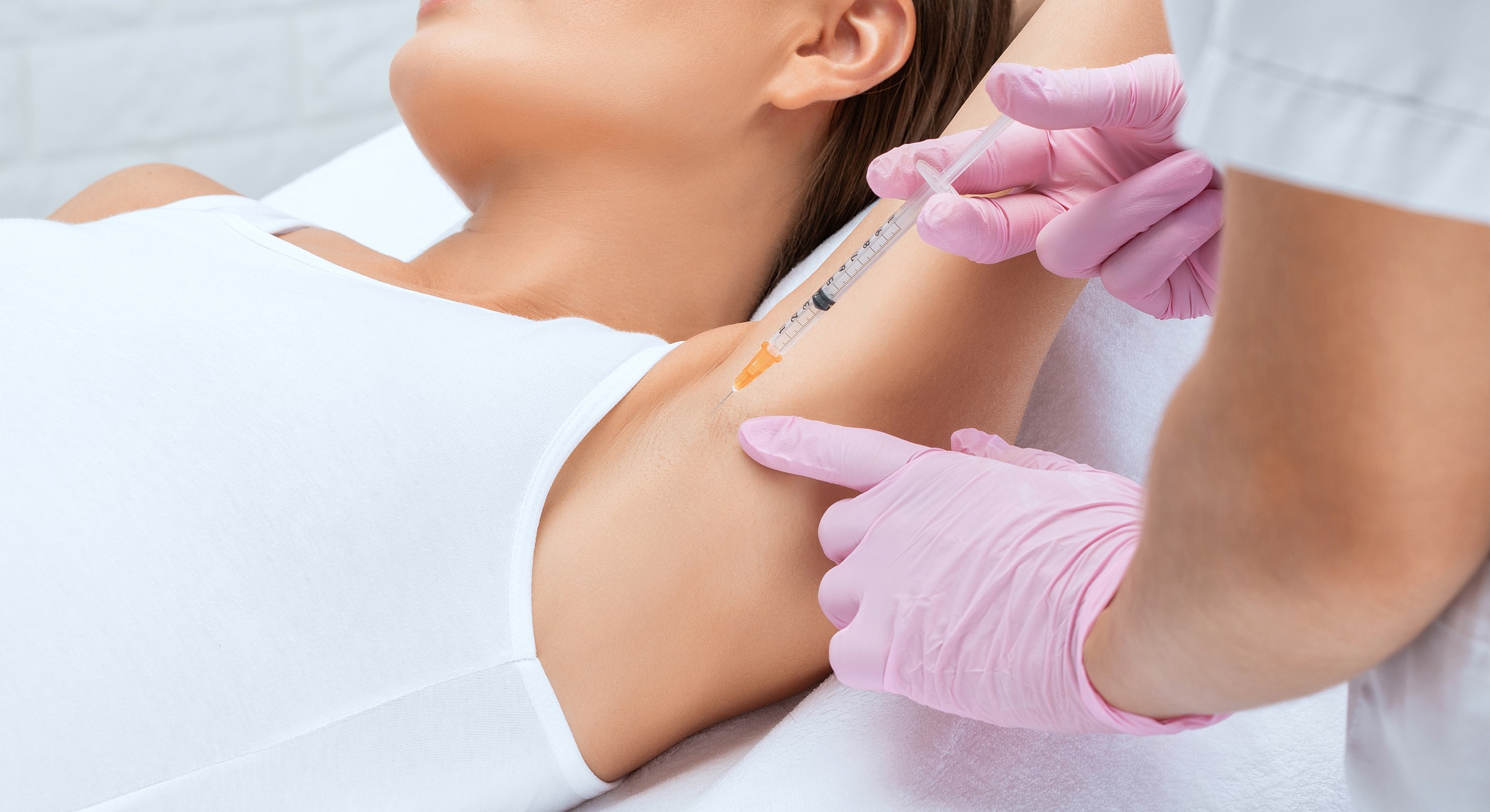 Injection being administered in underarm area.