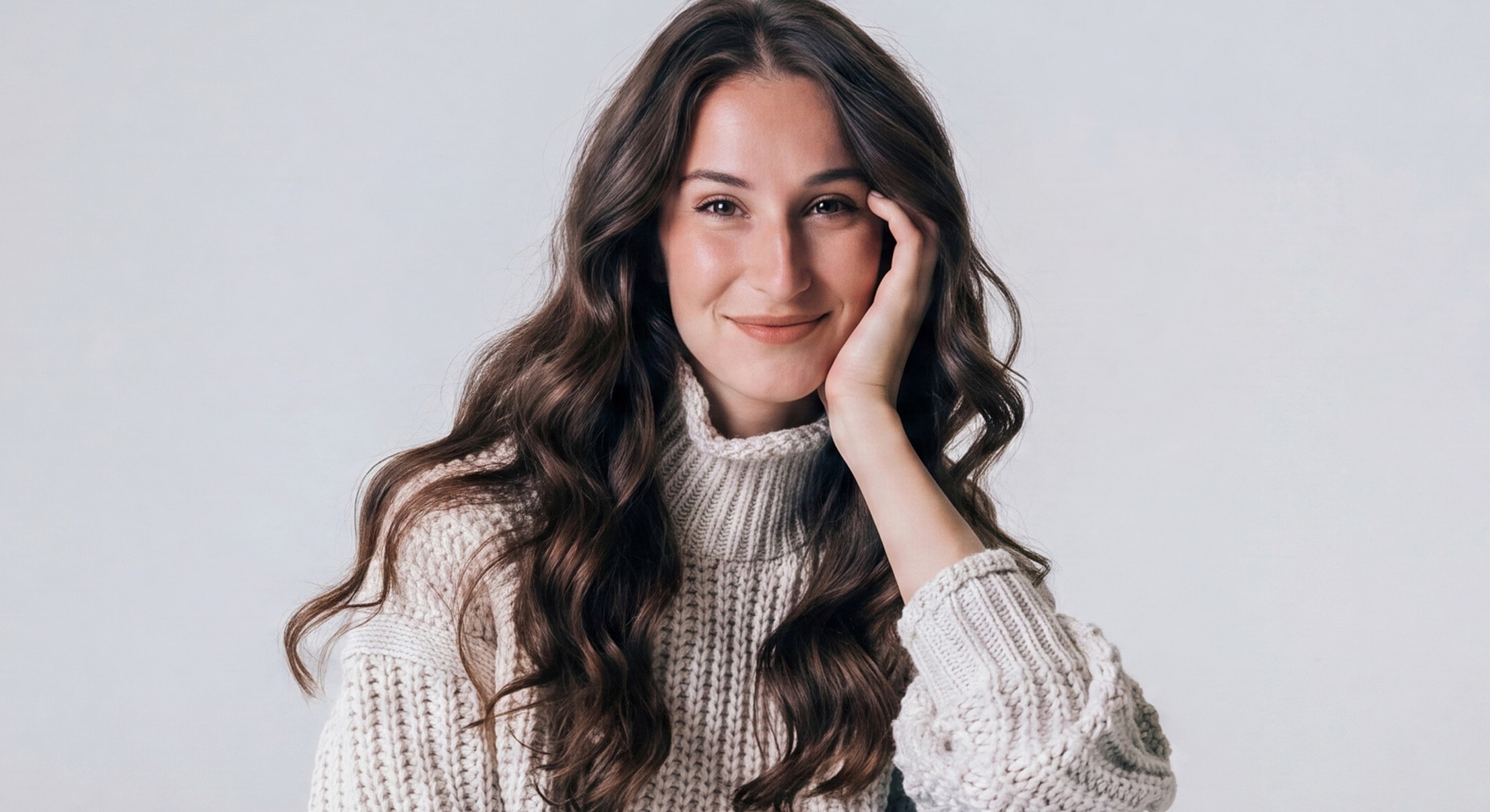 Smiling woman with long, wavy hair.