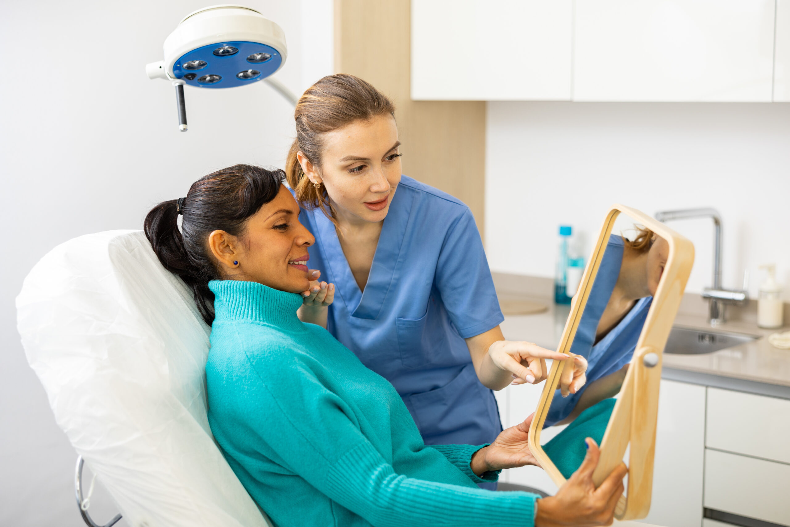 A patient and a medical professional reviewing lip filler results after a Revanesse Versa treatment.