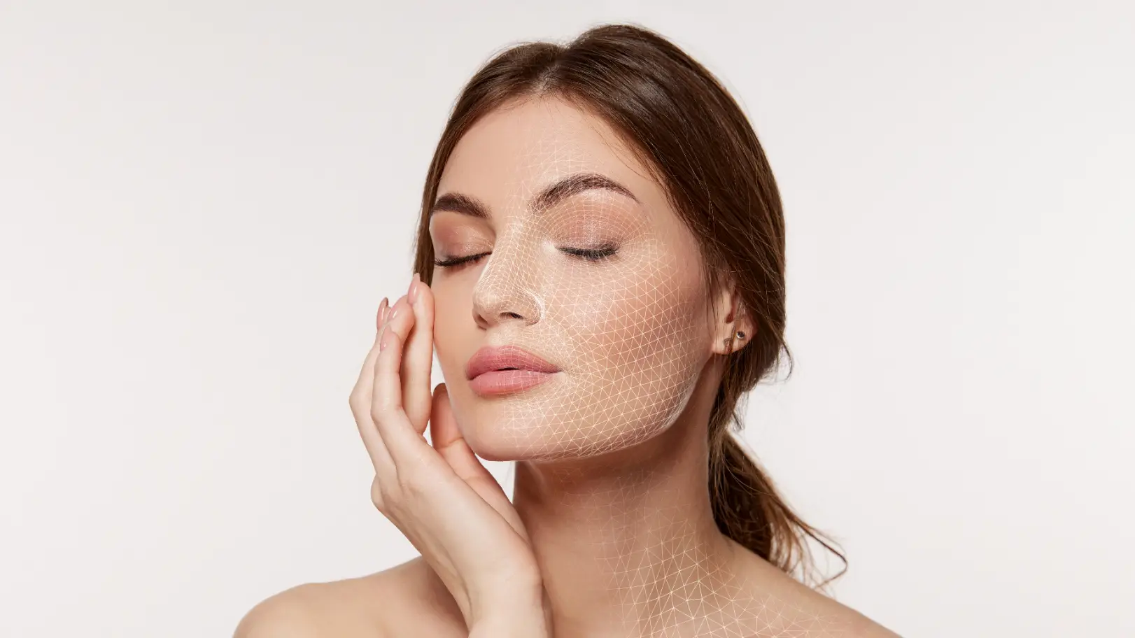 Woman with closed eyes touching her cheek with a white geometric mesh overlay across her face and neck.